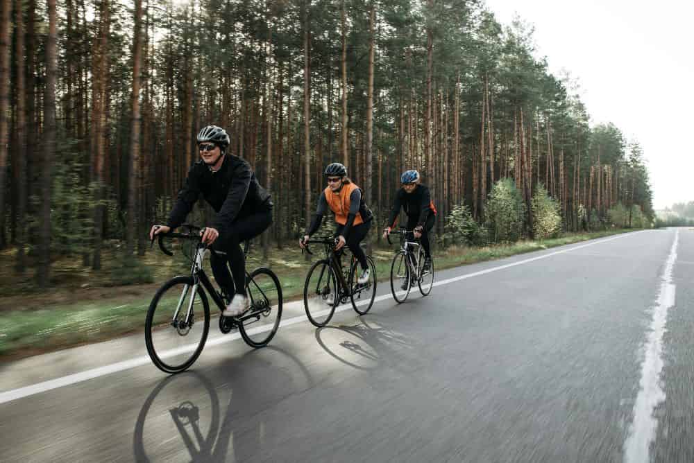 people riding bicycles on a road